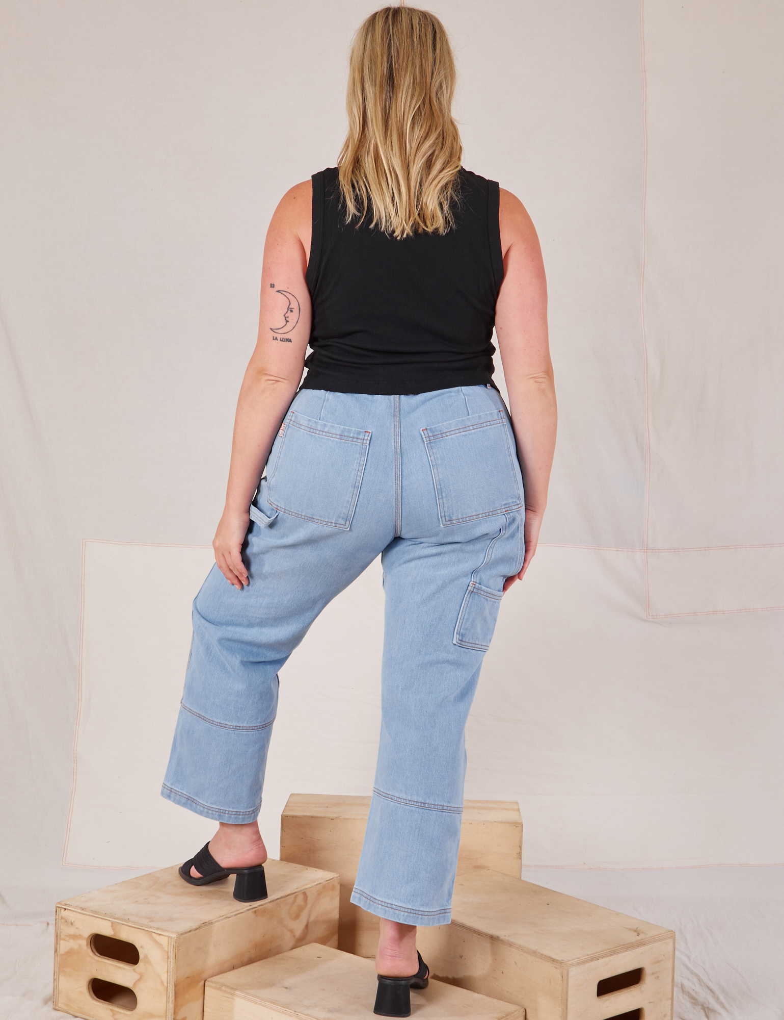 Back view of Muscle Tee in Basic Black and light wash Carpenter Jeans on Lish