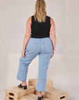 Back view of Muscle Tee in Basic Black and light wash Carpenter Jeans on Lish