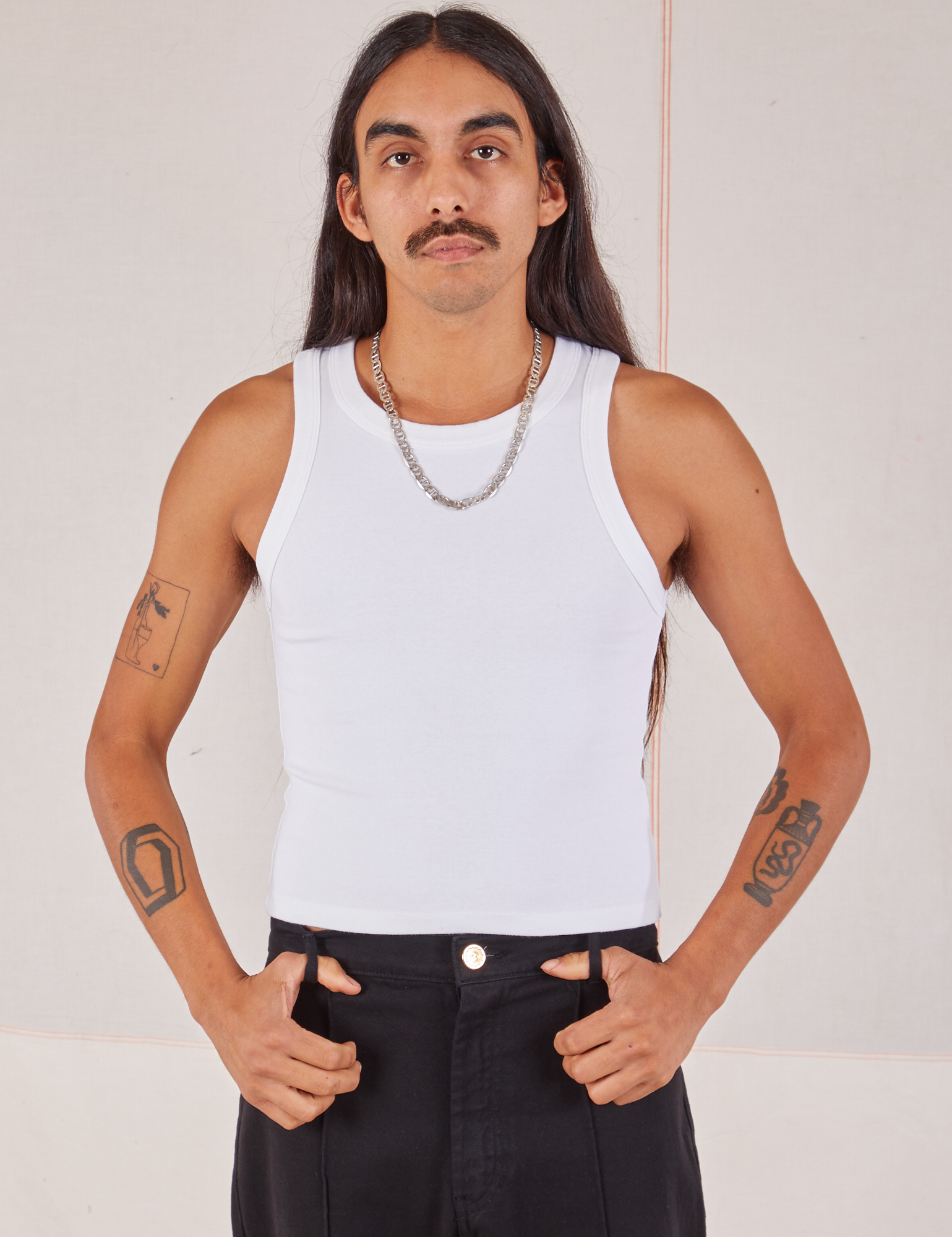 Anthony is wearing Racerback Tank in Vintage Tee Off-White