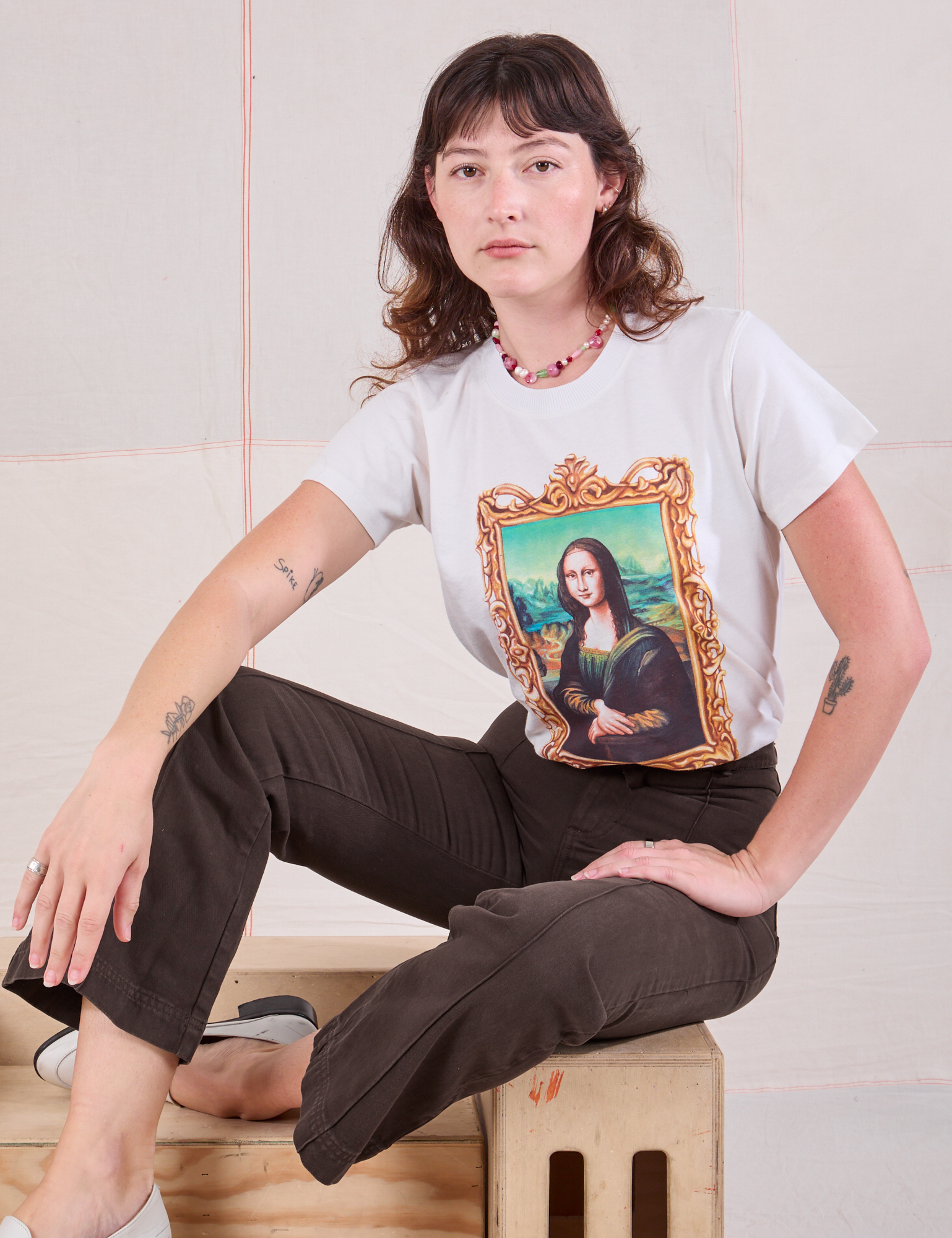 Alex is wearing Masters Organic Tee in Mona Lisa and espresso brown Western Pants