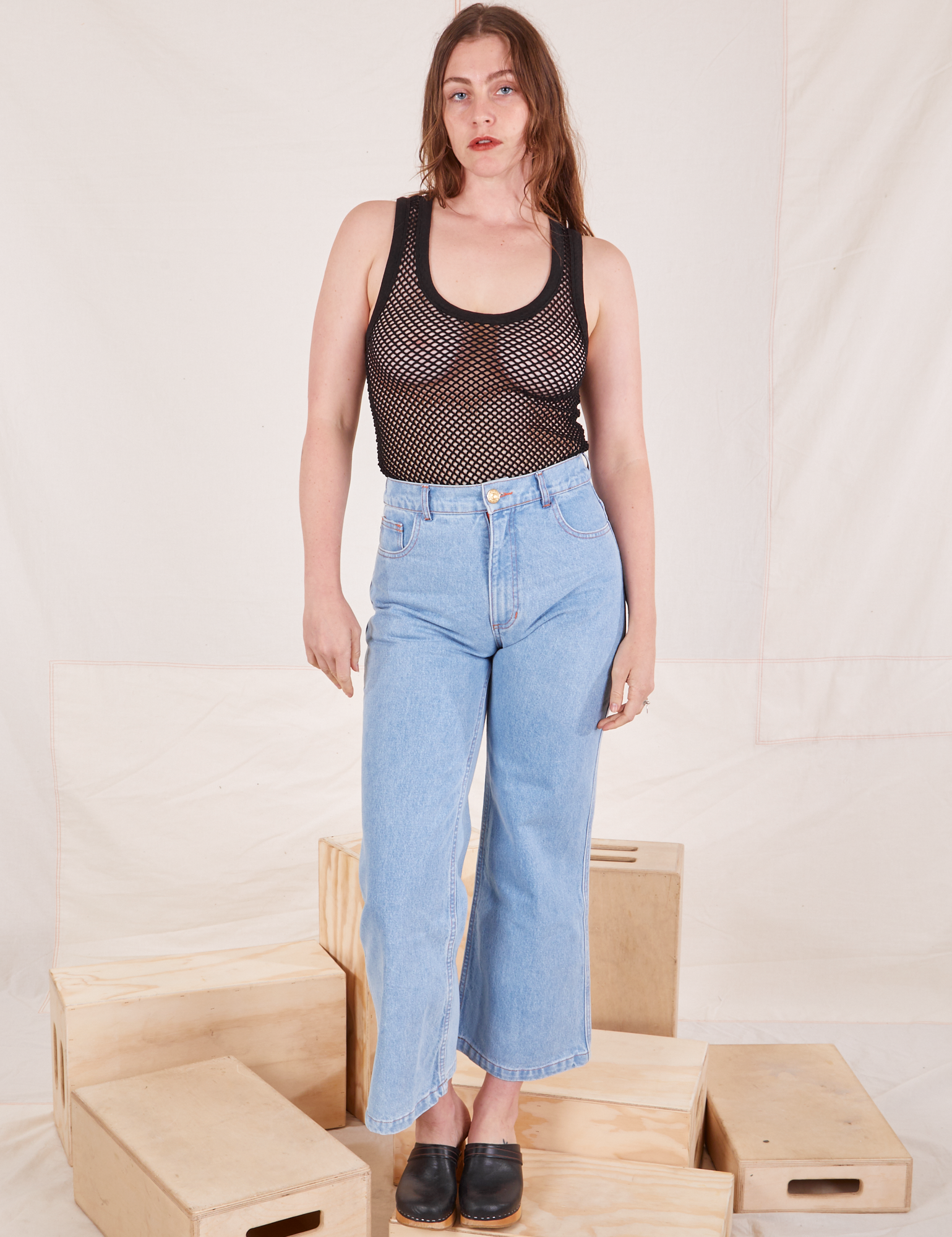 Allison is 5&#39;10 and wearing XXS Mesh Tank Top in Basic Black paired with light wash Sailor Jeans