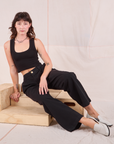 Alex is wearing Mid-Rise Pleated Trousers in Basic Black and black Cropped Tank