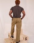 Back view of Mid-Rise Pleated Trousers in Desert Brown and espresso brown Organic Vintage Tee on Issac