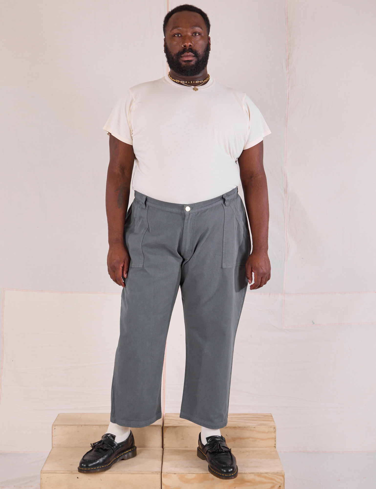 Elijah is 6&#39;3&quot; and wearing 1XL Mid-Rise Work Pants in Slate Grey paired with an Organic Vintage Tee in vintage tee off-white