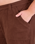 Mid-Rise Work Pants in Fudgesicle Brown close up of Juliet's hand in the pocket