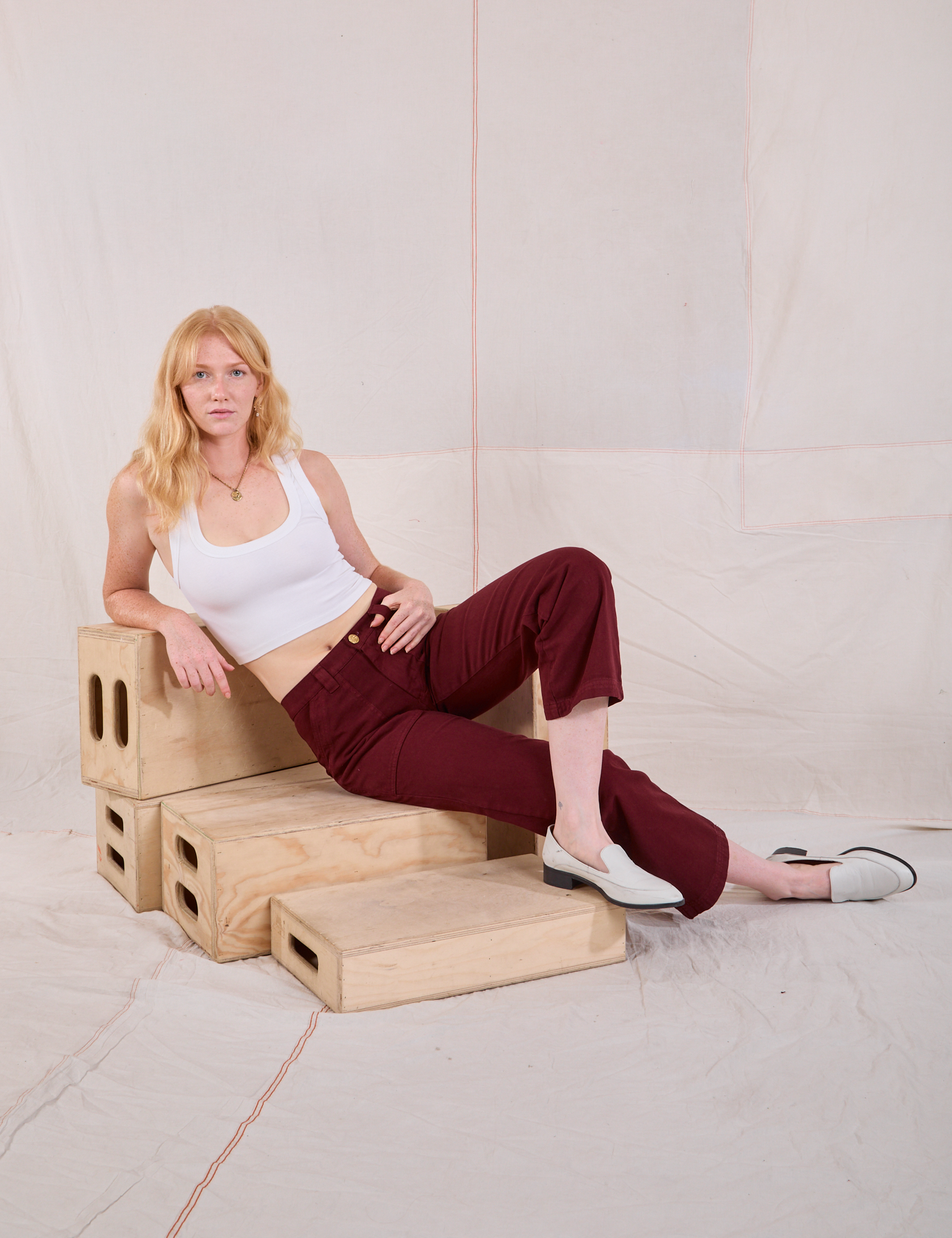 Margaret is wearing Mid-Rise Work Pants in Red Wine and Cropped Tank in vintage tee off-white