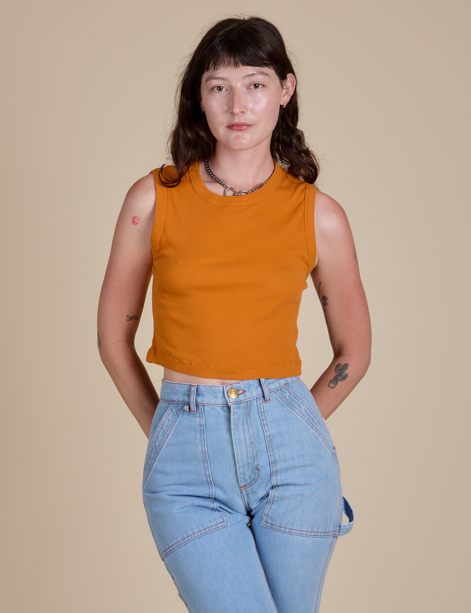 Alex is 5’8” and wearing XP Muscle Tee in Creamsicle Orange