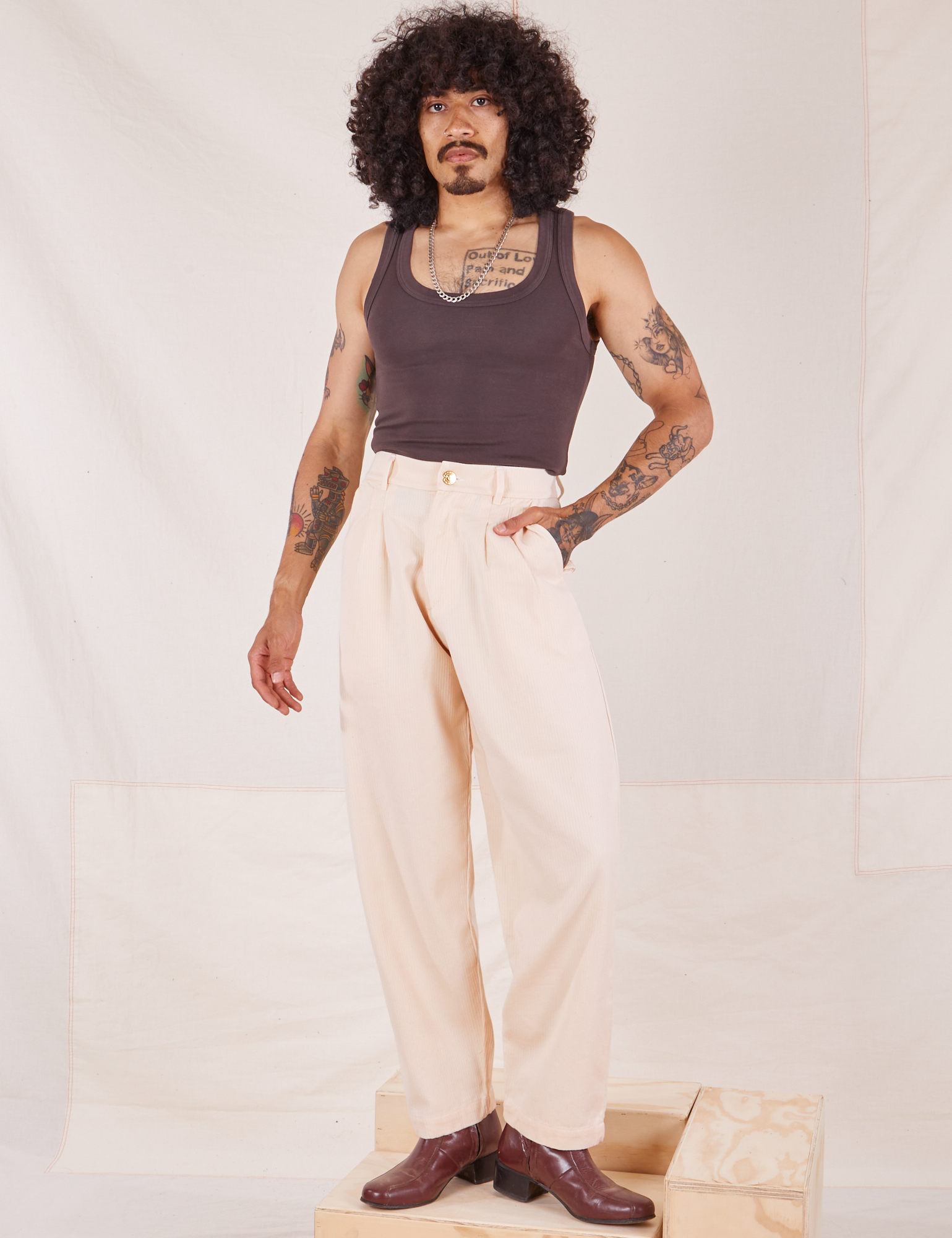 Jesse is 5&#39;8&quot; and wearing XS Heritage Trousers in Vintage Off-White paired with espresso brown Tank Top