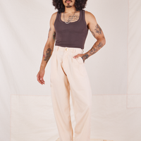 Jesse is 5'8" and wearing XS Heritage Trousers in Vintage Off-White paired with espresso brown Tank Top