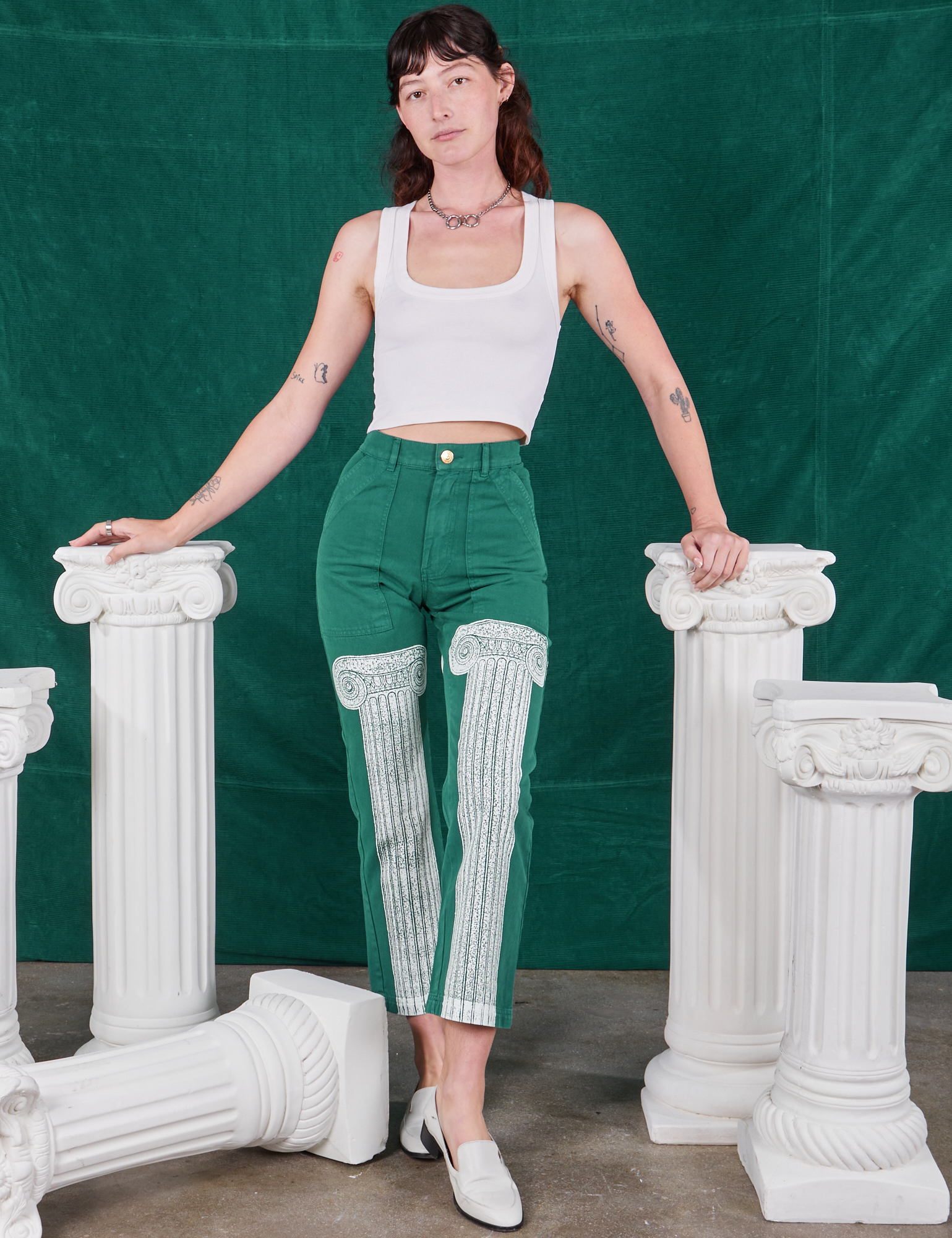 Alex is 5&#39;8&quot; and wearing XXS Column Work Pants in Hunter Green paired with vintage off-white Cropped Tank Top