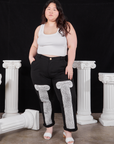 Ashley is 5'7" and wearing 1XL Column Work Pants in Basic Black paired with vintage off-white Cropped Tank Top