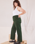 Side view of Organic Work Pants in Swamp Green and Racerback Tank in vintage tee off-white on Ryan