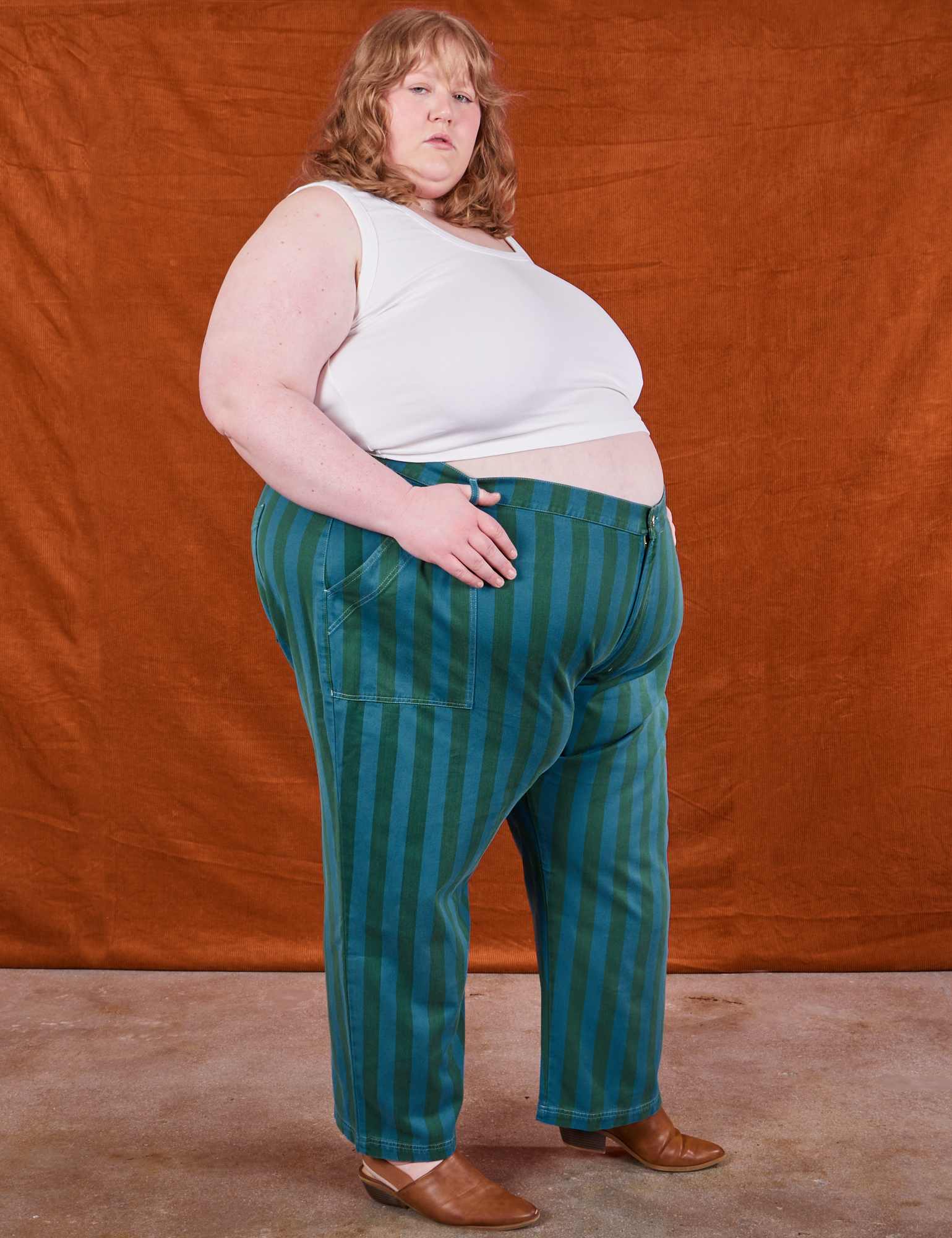 Side view of Overdye Stripe Work Pants in Blue/Green and vintage off-white Cropped Tank Top on Catie
