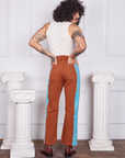 Back view of Hand-Painted Stripe Western Pants in Burnt Terracotta and vintage off-white Tank Top worn by Jesse. They also have both their hands in the back pockets