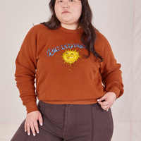 Ashley is 5'7" and wearing L Bill Ogden's Sun Baby Crew paired with espresso brown Western Pants