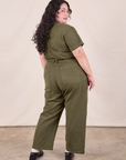 Petite Short Sleeve Jumpsuit in Surplus Green back view on Ari