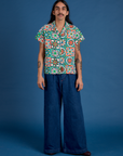 Anthony is wearing Quilt Print Pantry Button-Up and Indigo Wide Leg Trousers in Dark Wash