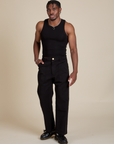 Isaac is wearing Racerback Tank in Black and Work Pants in Black