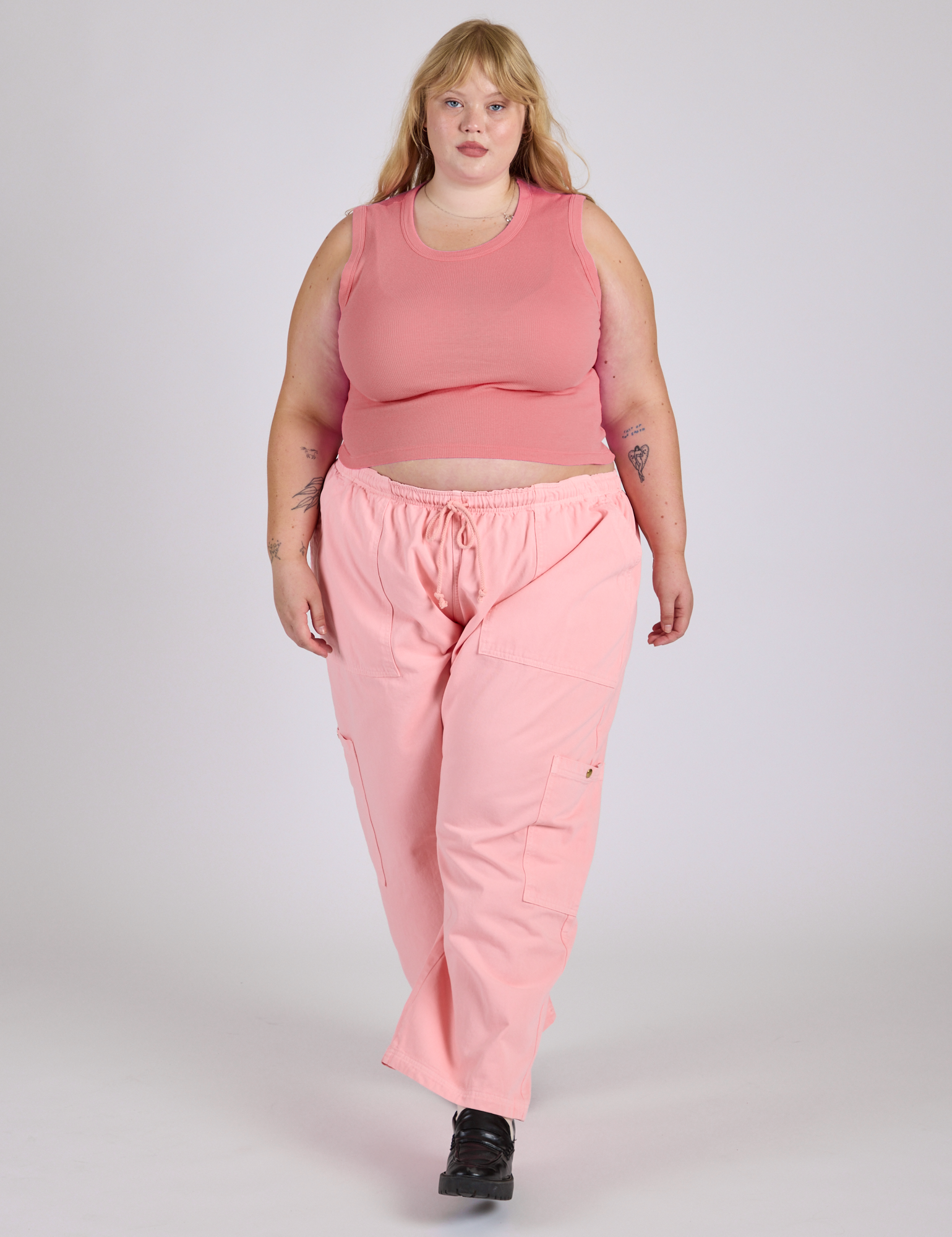 Juliet is wearing Drop Pocket Cargo Pants in Baby Pink and Muscle Tee