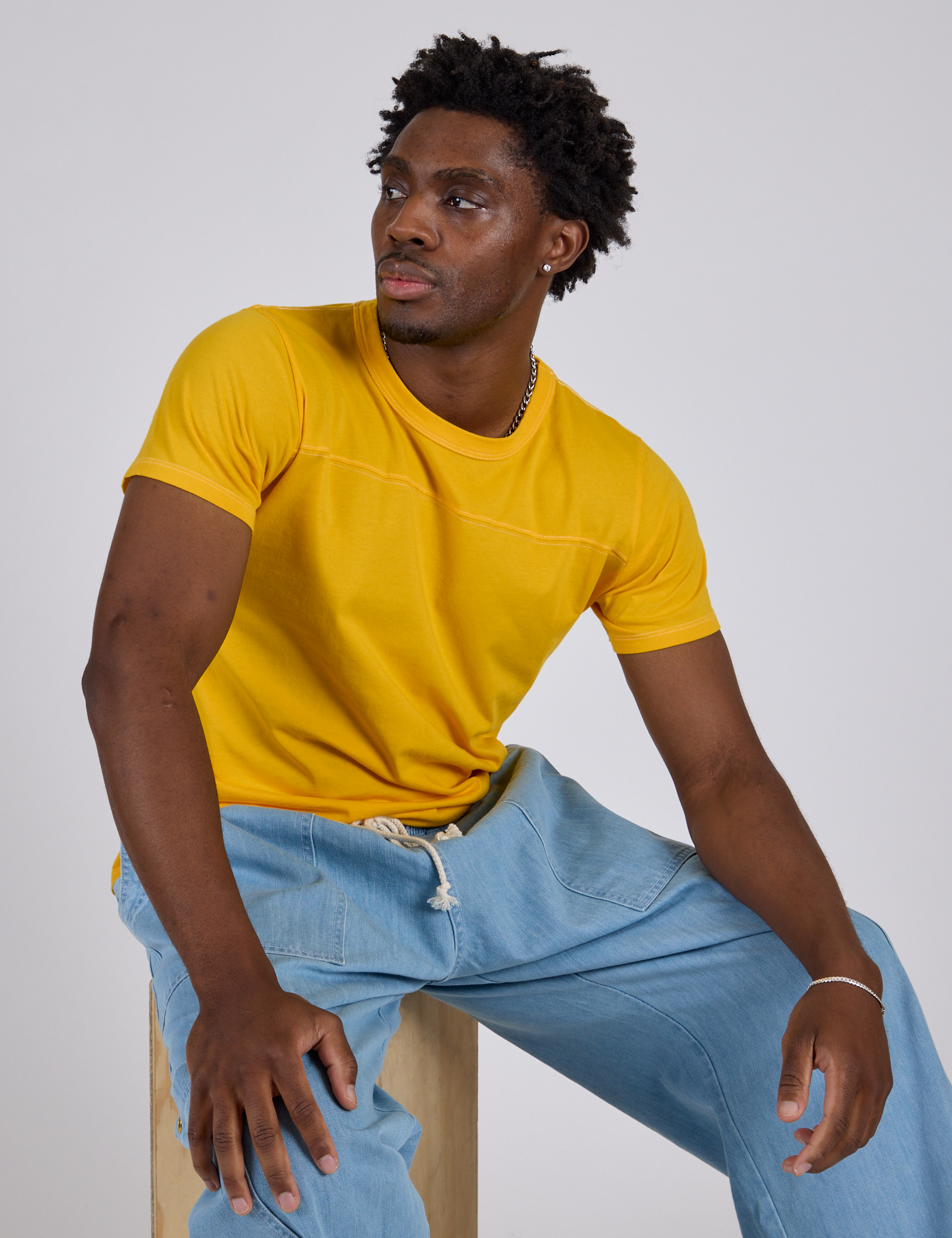 Jr. Varsity Tee in Sunshine Yellow and light wash Drop Pocket Pants worn by Isaac