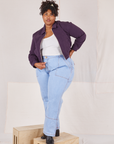 Morgan is wearing Ricky Jacket in Nebula Purple and light wash Carpenter Jeans