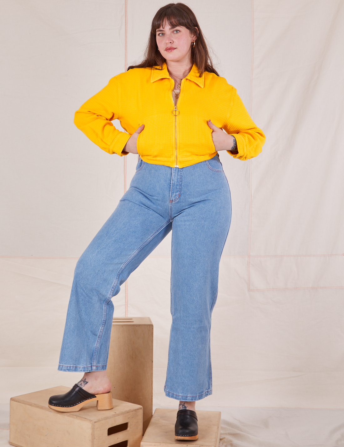 Sydney is 5'9" and wearing XS Ricky Jacket in Sunshine Yellow with both hands in the pockets