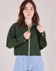 Hana is 5’3” and wearing P Ricky Jacket in Swamp Green