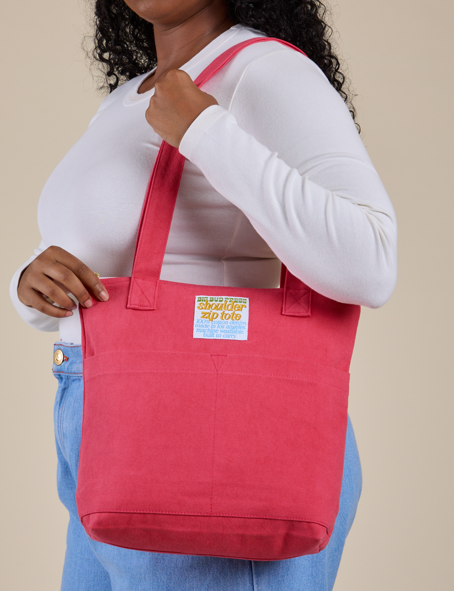 Over-Shoulder Zip Mini Tote in Hot Pink worn on shoulder of model