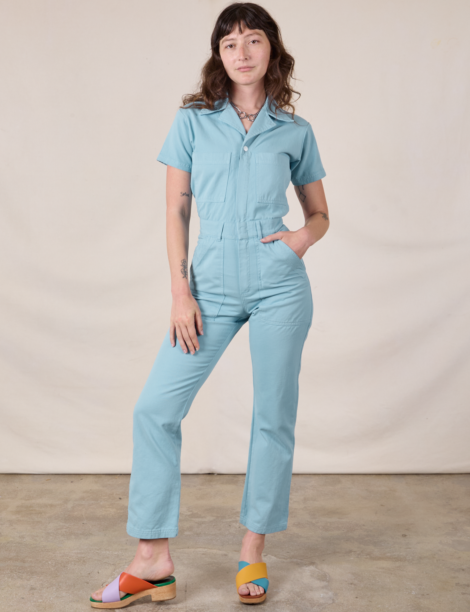 Alex is 5&#39;8&quot; and wearing XXS Short Sleeve Jumpsuit in Baby Blue