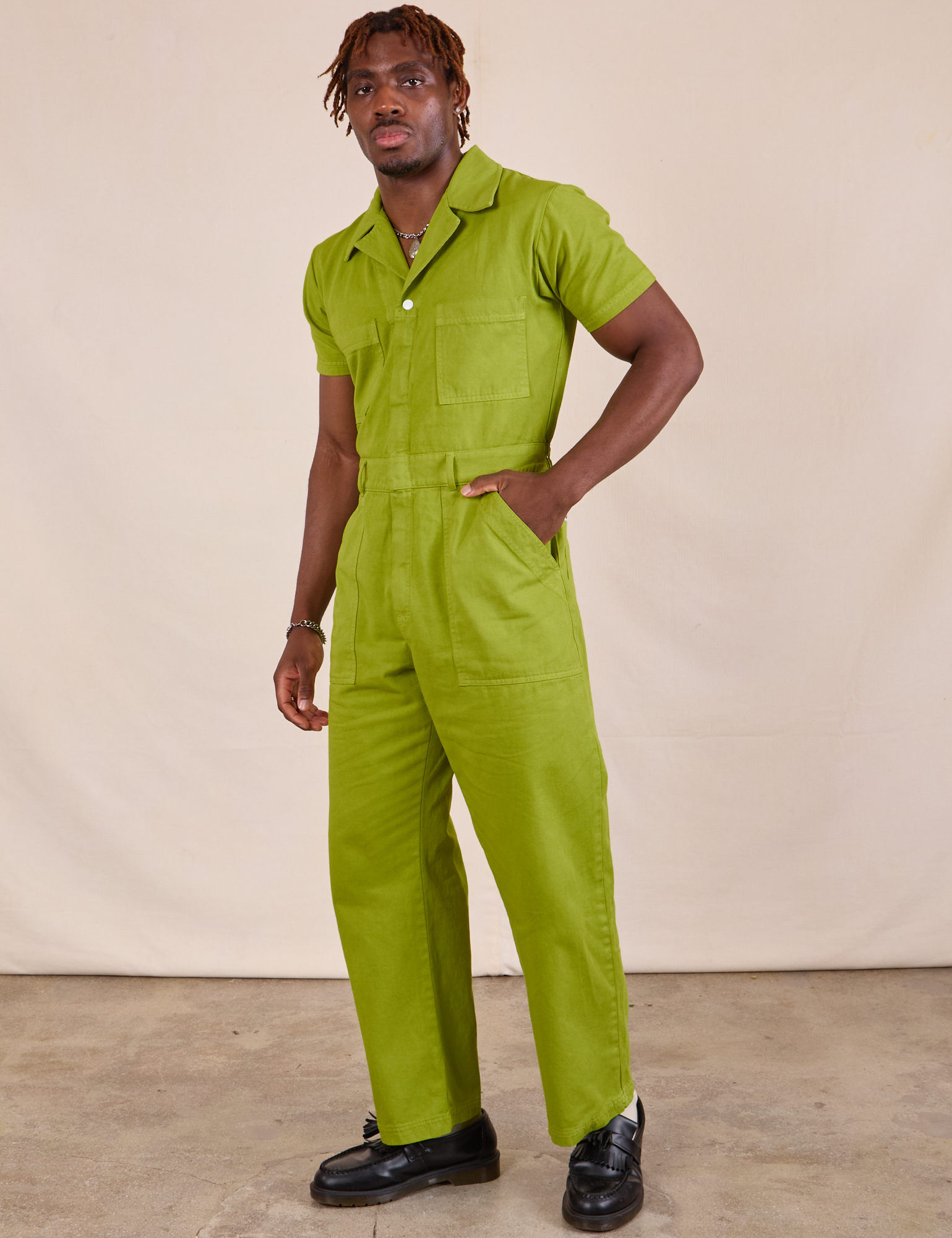 Short Sleeve Jumpsuit in Gross Green angled front view on Issac