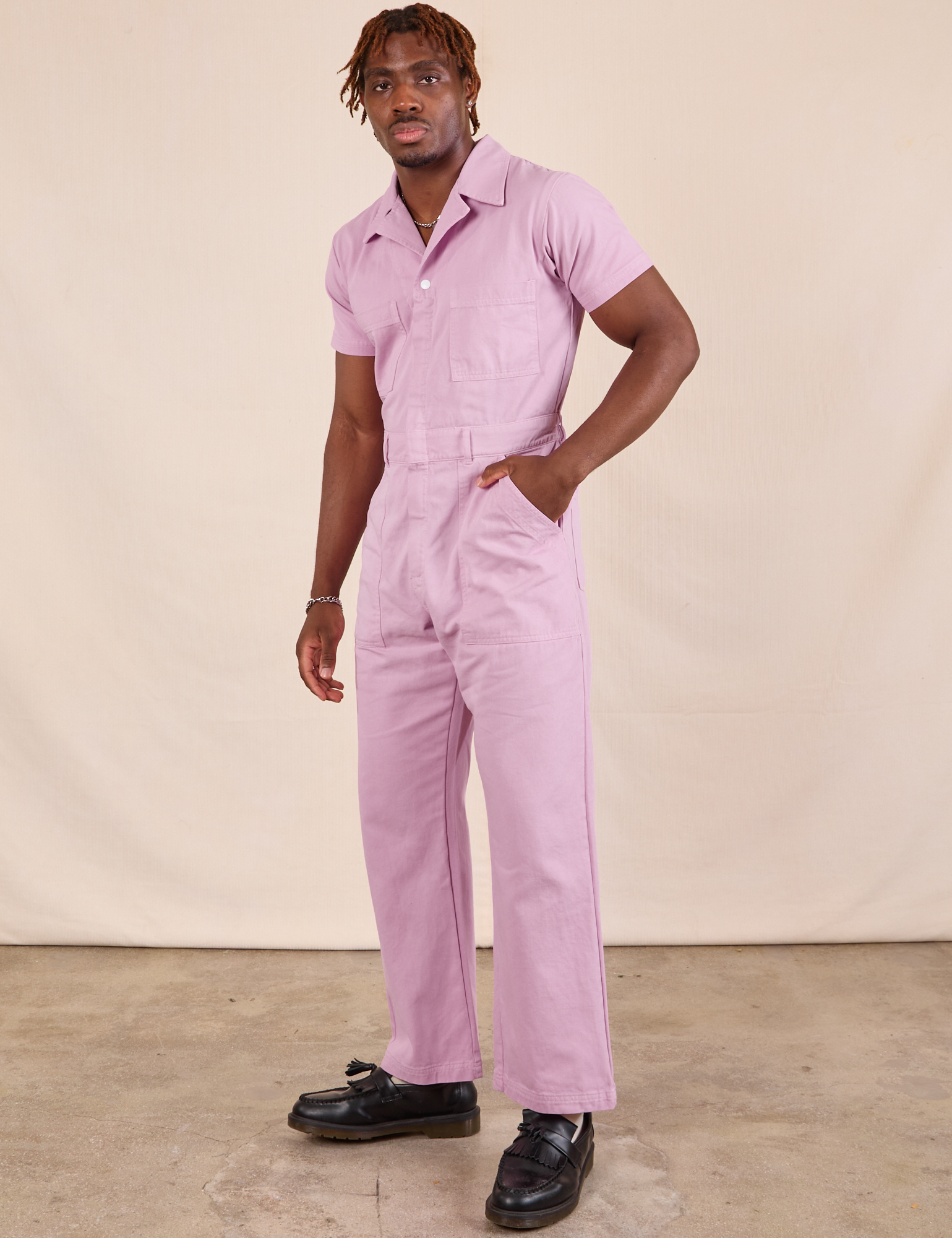 Issac is wearing Short Sleeve Jumpsuit in Lilac