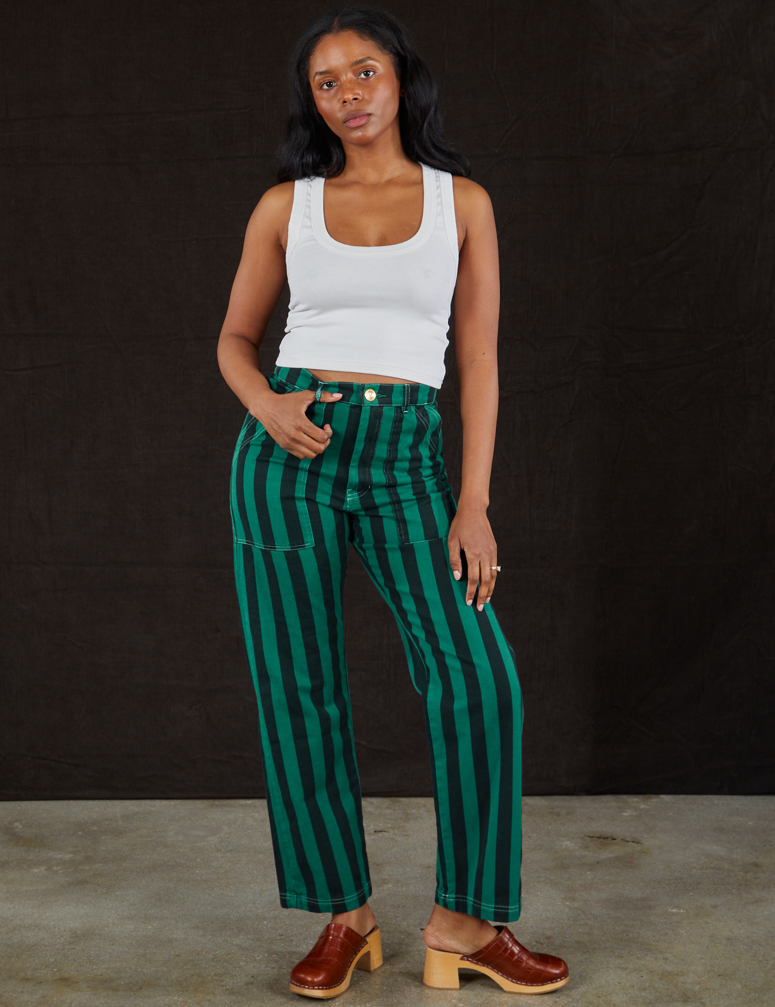 Kandia is 5&#39;3&quot; and wearing S Black Stripe Work Pants in Hunter paired with vintage off-white Cropped Tank Top