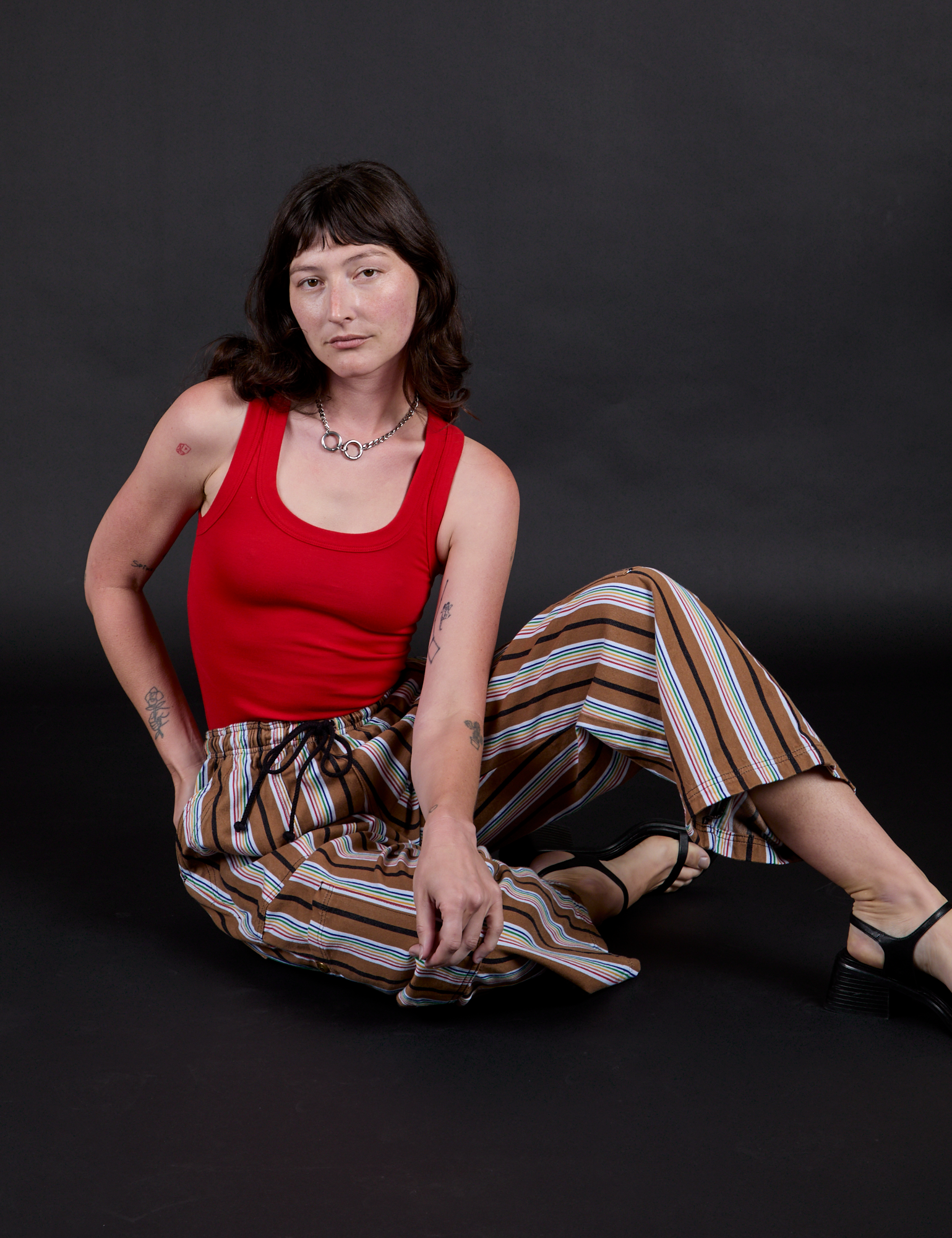 Striped Drop Pocket Pants in Retro Rainbow and mustang red Tank Top worn by Alex