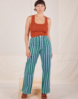 Tiara is 5'4" and wearing S Stripe Work Pants in Green paired with burnt terracotta Cropped Tank
