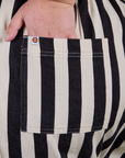 Close up of Juliet's hand in the back pocket of Longline Work Shorts in Natural