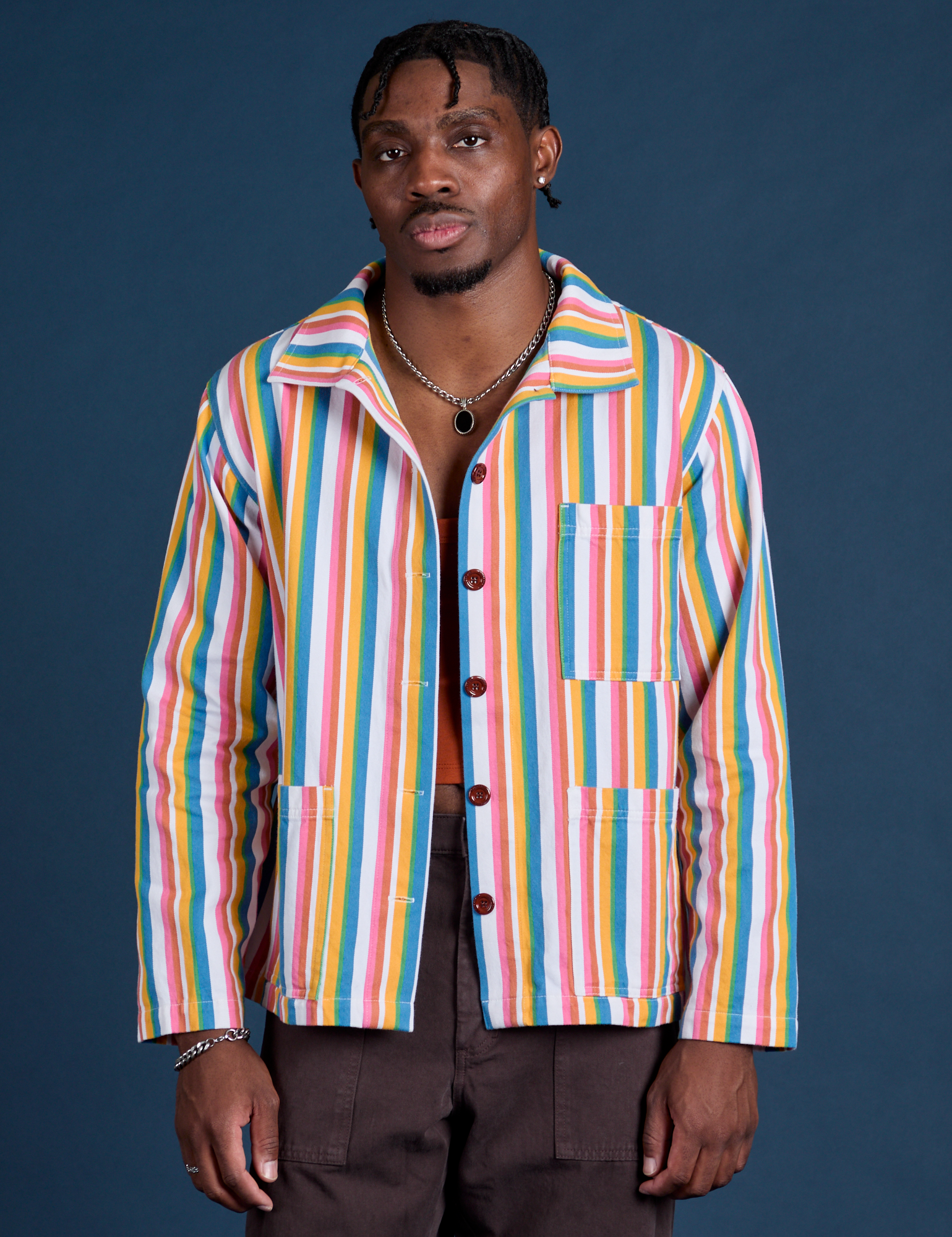 Isaac is 5’10” and wearing M Stripe Work Jacket in Rainbow Stripe