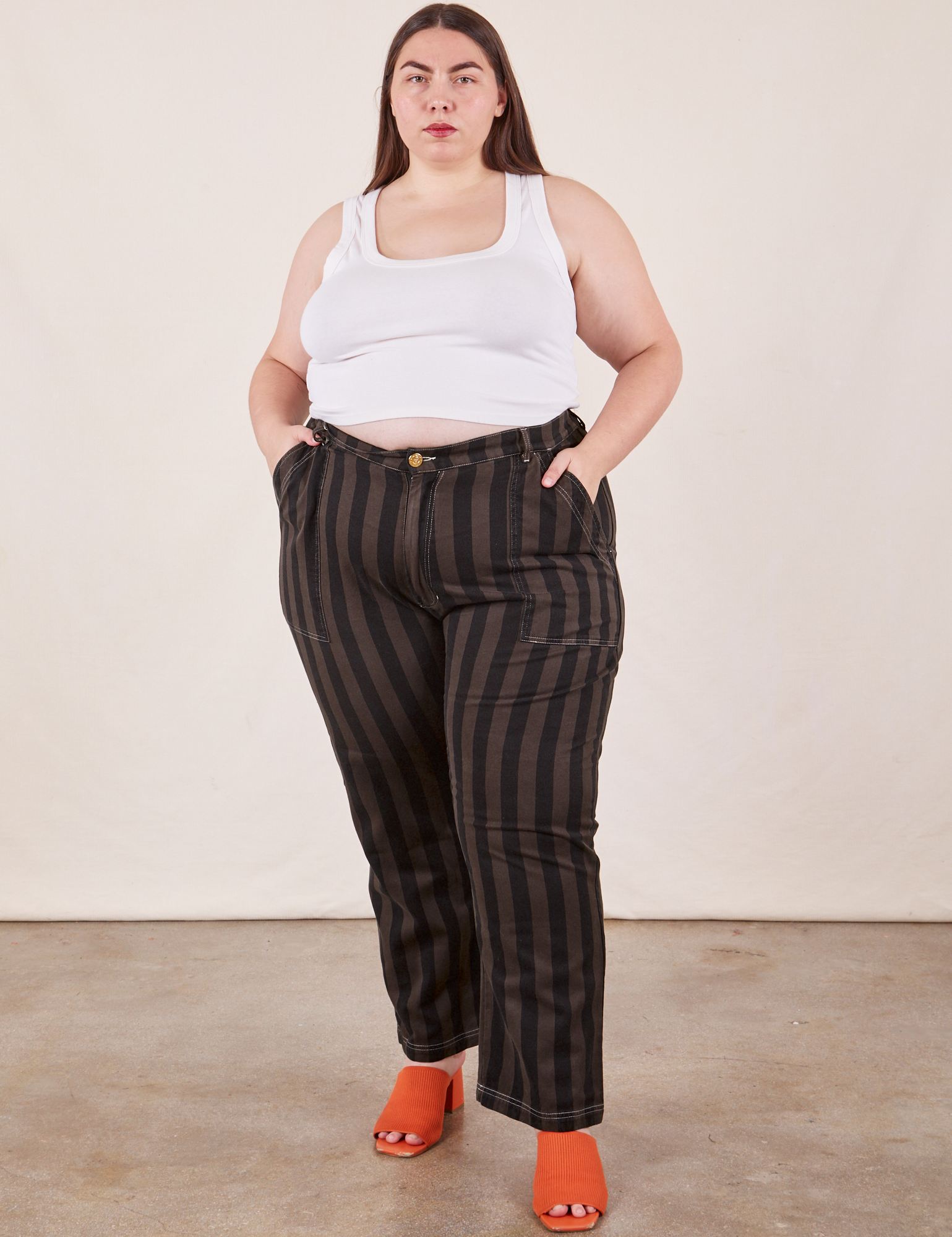 Marielena is 5&#39;8&quot; and wearing 2XL Black Striped Work Pants in Espresso paired with vintage off-white Cropped Tank Top