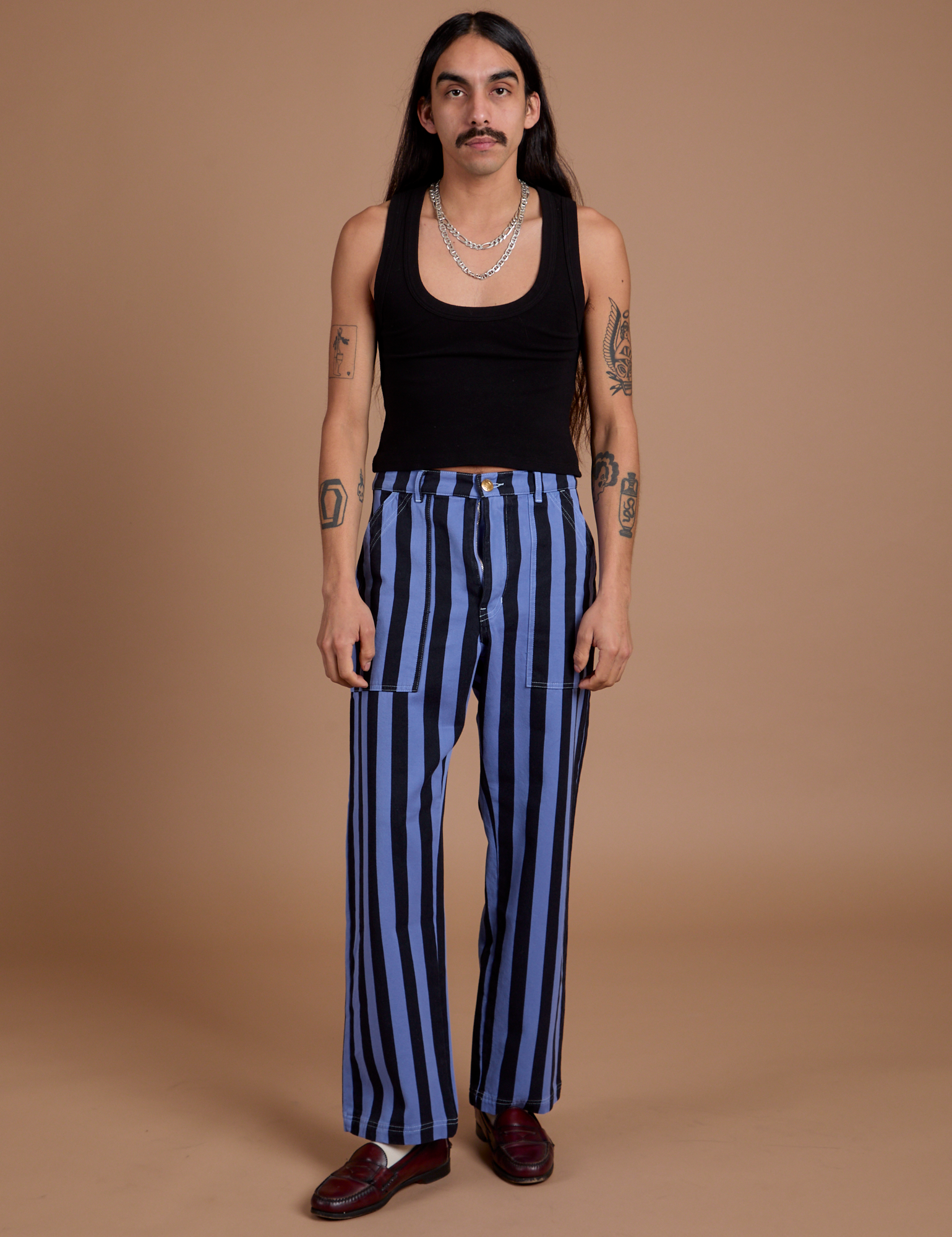 Anthony is 5’6” and wearing S Black Stripe Work Pants in Cornflower Blue