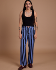 Anthony is 5’6” and wearing S Black Stripe Work Pants in Cornflower Blue