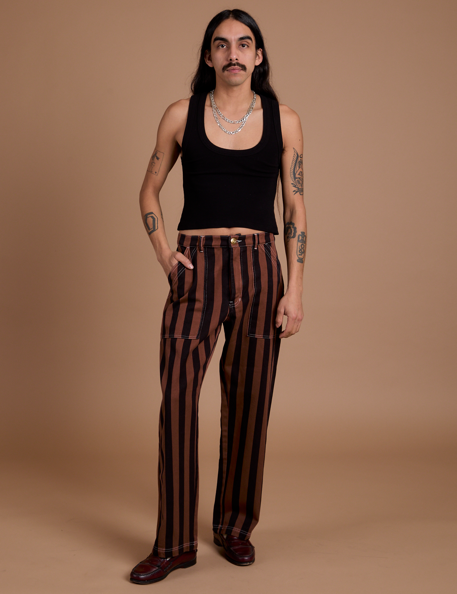 Anthony is 5’6” and wearing S Black Stripe Work Pants in Fudgesicle Brown