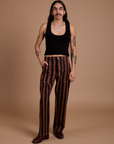 Anthony is 5’6” and wearing S Black Stripe Work Pants in Fudgesicle Brown