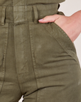 Short Sleeve Jumpsuit in Surplus Green front pocket close up on Alex