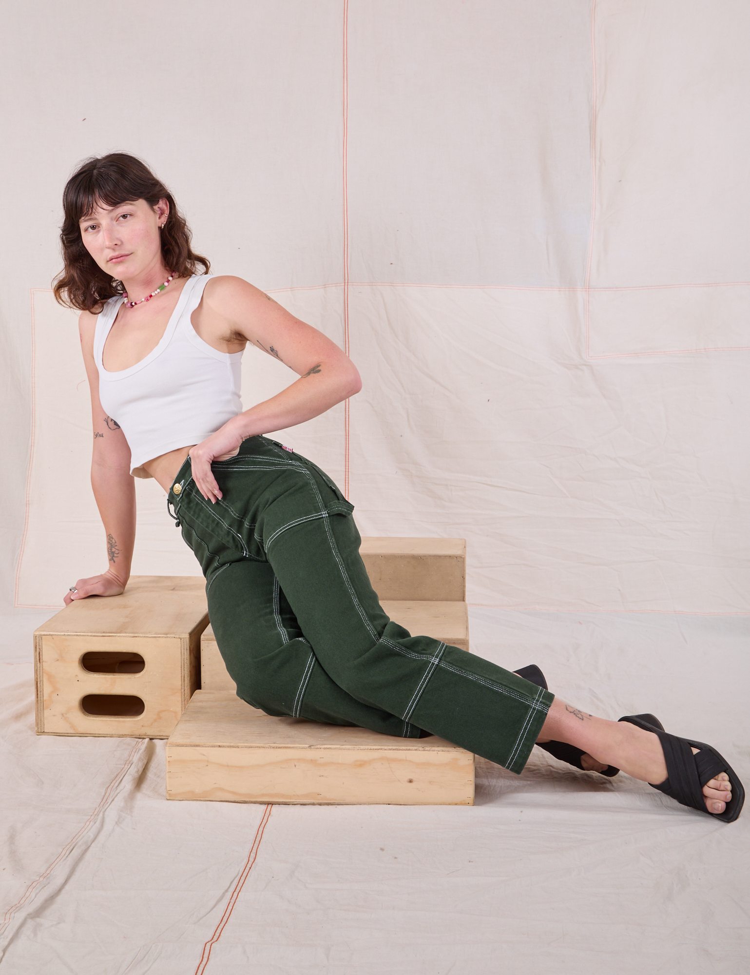 Carpenter Jeans in Swamp Green and Cropped Tank in Vintage Tee Off-White worn by Alex