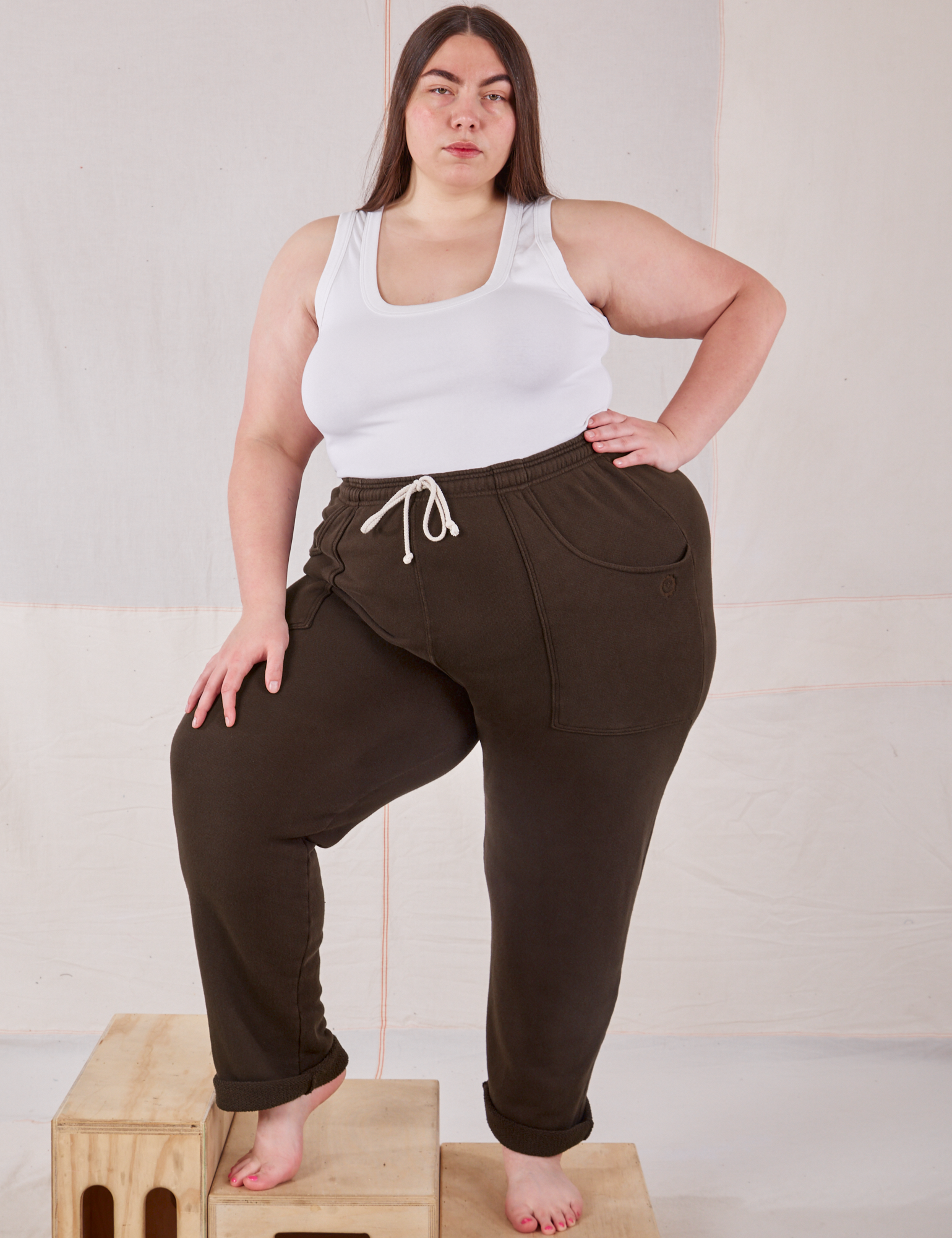 Marielena is wearing Rolled Cuff Sweat Pants in Espresso Brown and vintage off-white Cropped Tank