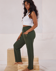 Side view of Rolled Cuff Sweat Pants in Swamp Green and Cropped Tank in vintage tee off-white on Kandia