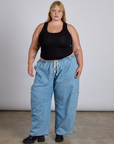 Juliet is wearing The Tank Top in Basic Black paired with light wash denim drop pocket pants