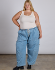 Juliet is wearing The Tank Top in Vintage Tee Off-White and light wash denim drop pocket pants