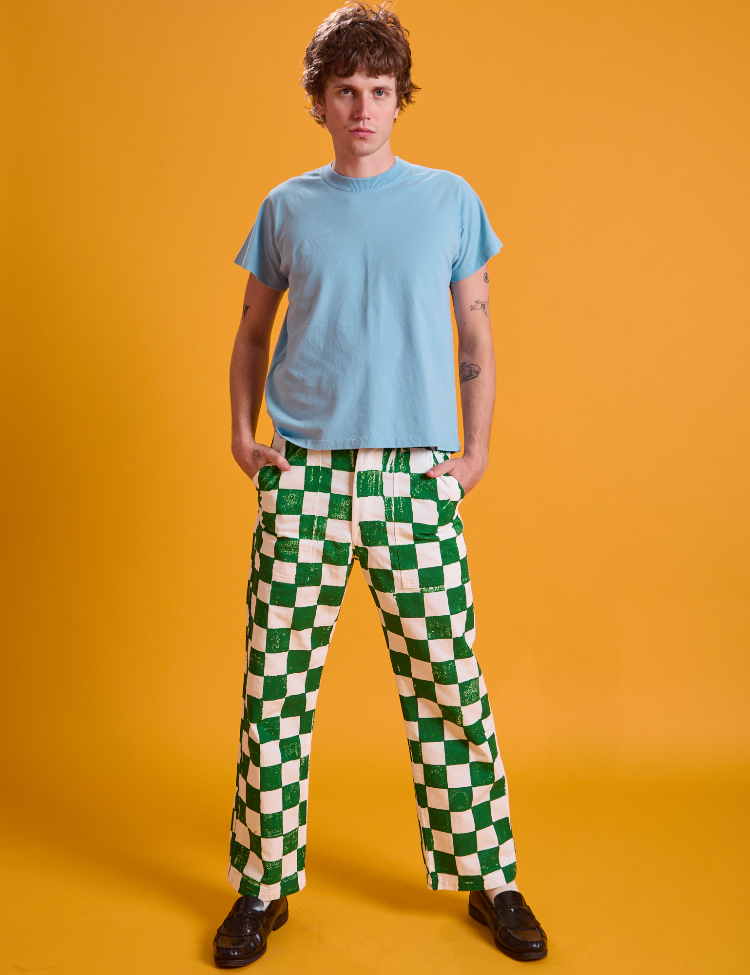 Quinn is 6&#39;3&quot; and wearing M Checkerboard Work Pants in White/Green paired with a baby blue Organic Vintage Tee