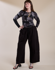 Sydney is 5'9" and wearing XXS Long Sleeve Baby Tee in Ink Blot paired with black Drop Pocket Cargo Pants