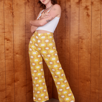 Alex is 5'8" and wearing XS Western Pants in Yellow Jacquard